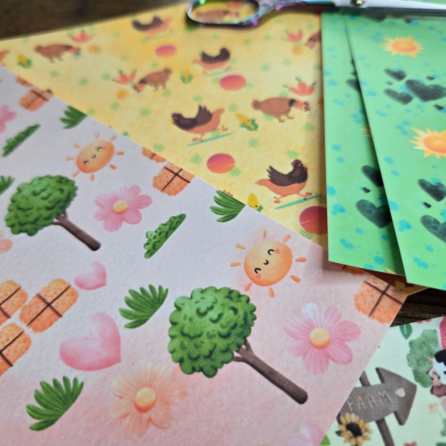 Colorful paper sheets with nature-themed designs on a wooden surface