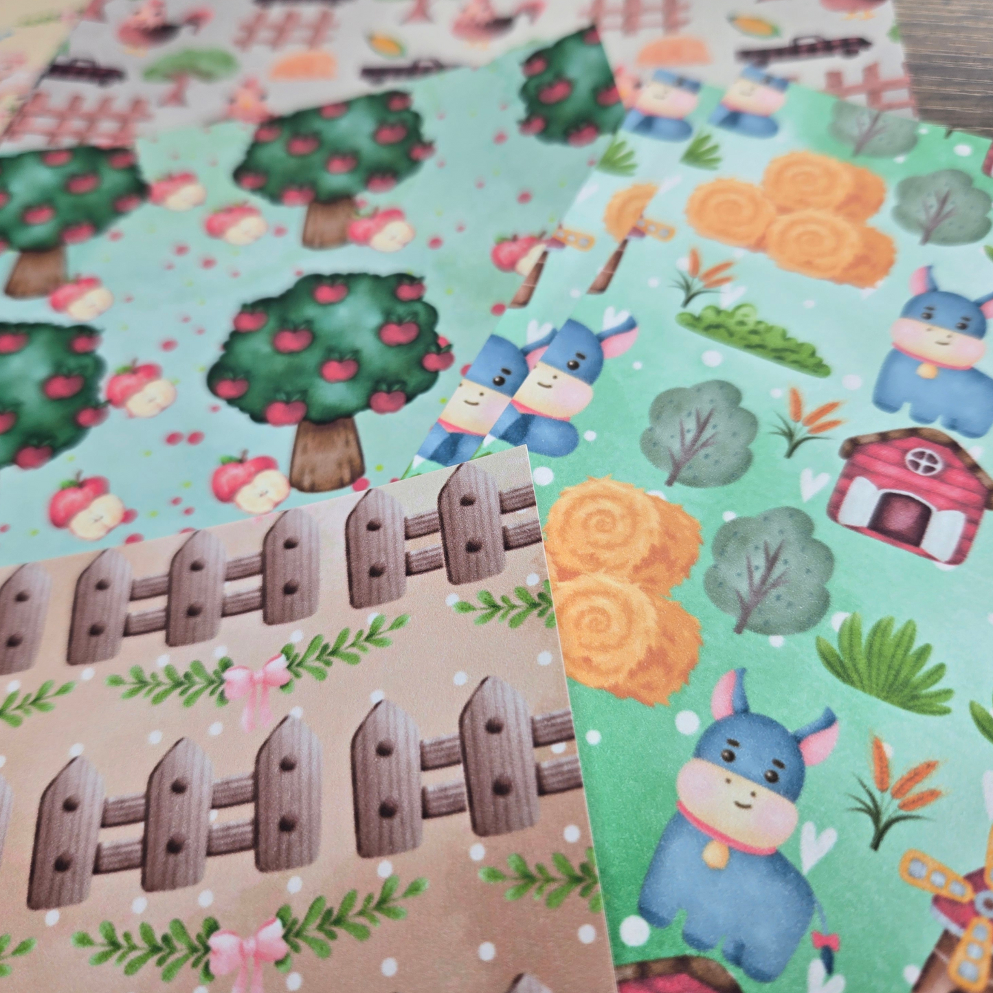 Children's papers with donkeys, trees, and houses on colorful backgrounds