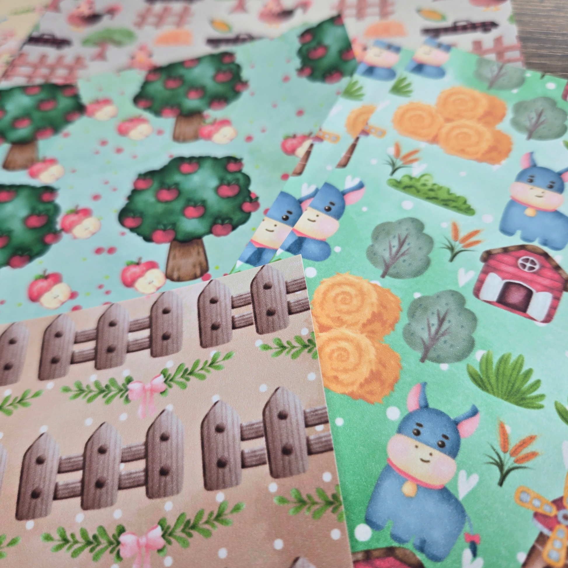 Children's papers with donkeys, trees, and houses on colorful backgrounds